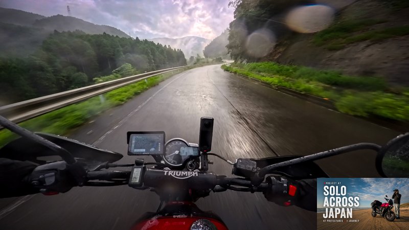 Motorcycle POV riding a wet mountain road in Saga during a summer storm in Japan