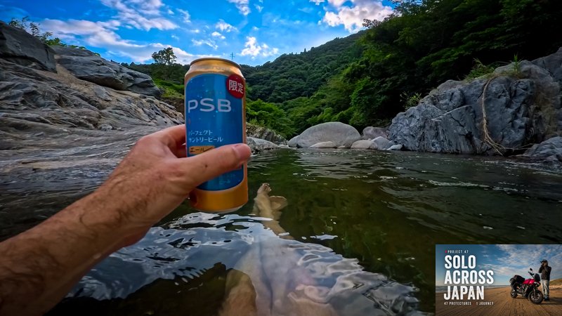 Wild swimming in a clear mountain river during a motorcycle camping trip through Saga Prefecture