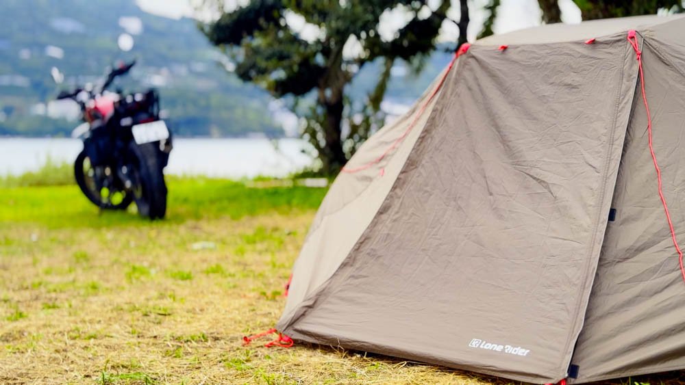 Motorcycle and tent beside the water at a campsite in Ehime, Shikoku