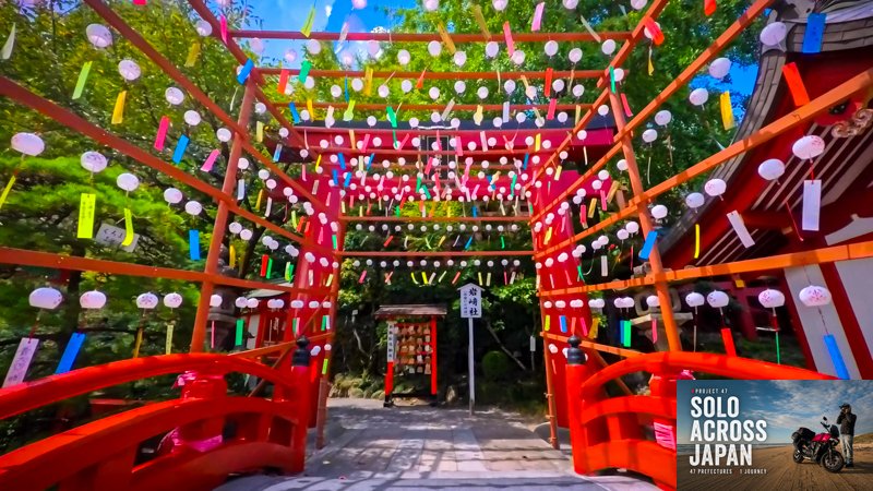 Yutoku Inari Shrine with red bridge and colorful wind chimes during a motorcycle trip through Saga