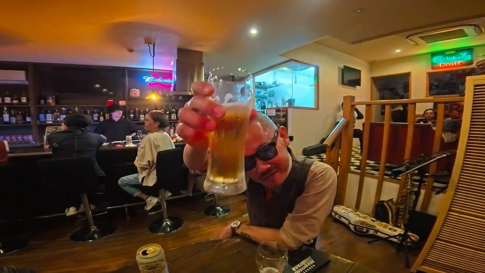 Raising a beer with a Inoue san inside a bar in Ehime