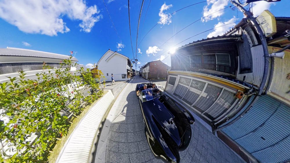 Adam riding through the streets of Ozu, Ehime, in a black Shelby Cobra for the first time