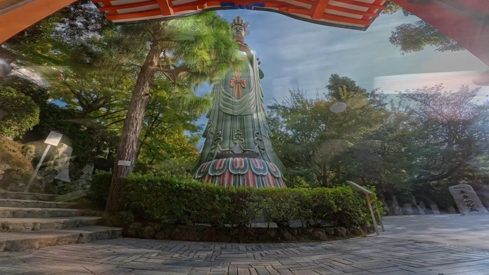 Large Buddhist statue surrounded by trees at Kosan-ji Temple in Hiroshima