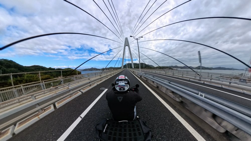 Motorcycle rider crossing a bridge through Hiroshima Prefecture Shimanami Kaido