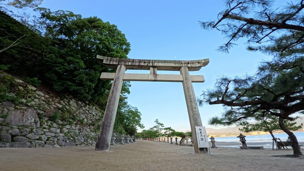 Stone torii gate beside the waterfront on Miyajima, Hiroshima