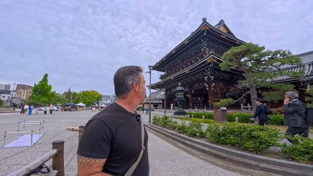 Adam looking toward a traditional Buddhist temple near Kyoto Station while exploring the city on foot