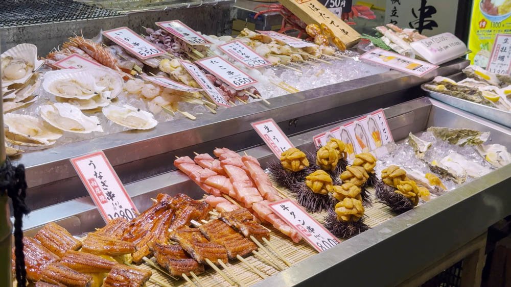 Fresh seafood, scallops, sea urchin, eel and shellfish displayed at Nishiki Market in Kyoto