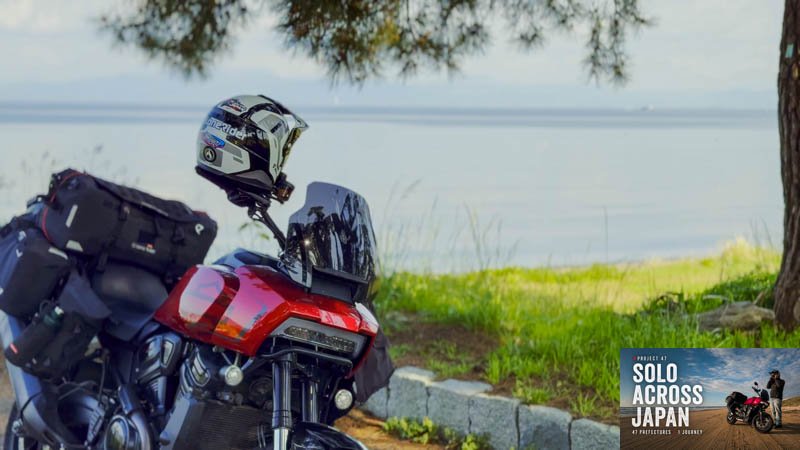 Red Harley-Davidson Pan America ST parked beside Lake Biwa in Shiga