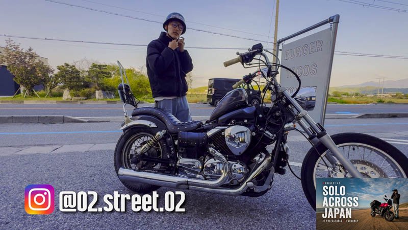 Ippei standing beside his customised Yamaha DragStar motorcycle in Shiga