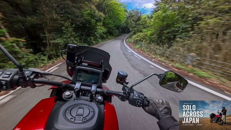 Motorcycle riding along a narrow forest road beside Lake Biwa in Shiga