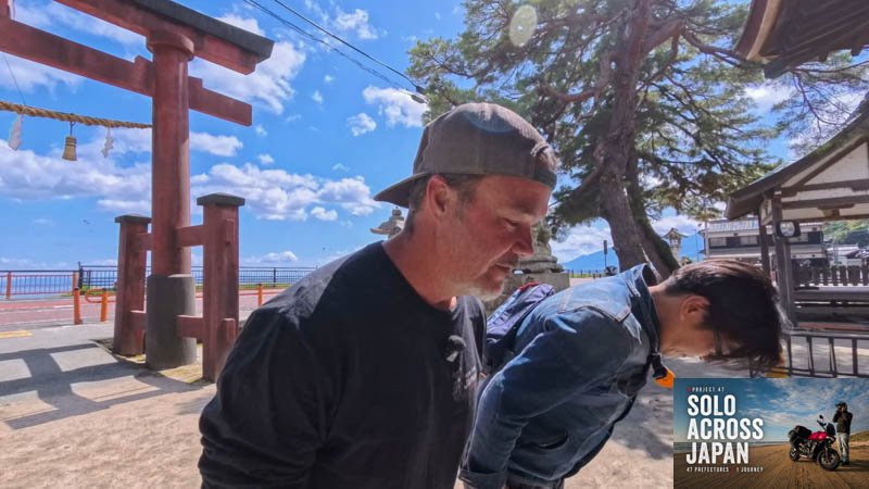 Local rider showing me how to pray at Shirahige Shrine in Shiga, Japan