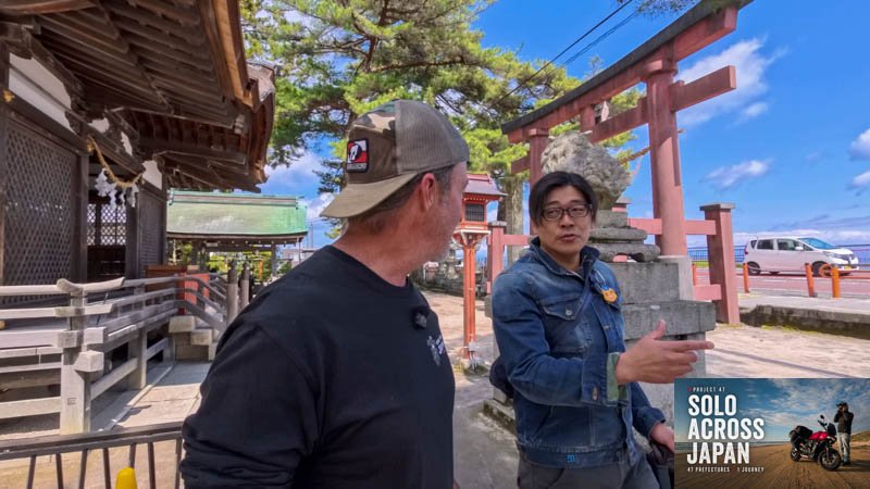 Talking with a local motorcycle rider at Shirahige Shrine beside Lake Biwa